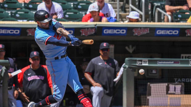 Jun 23, 2022; Minneapolis, Minnesota, USA; Minnesota Twins infielder Carlos Correa (4) hits a single against the Cleveland Guardians during the sixth inning at Target Field. Mandatory Credit: Nick Wosika-USA TODAY Sports
